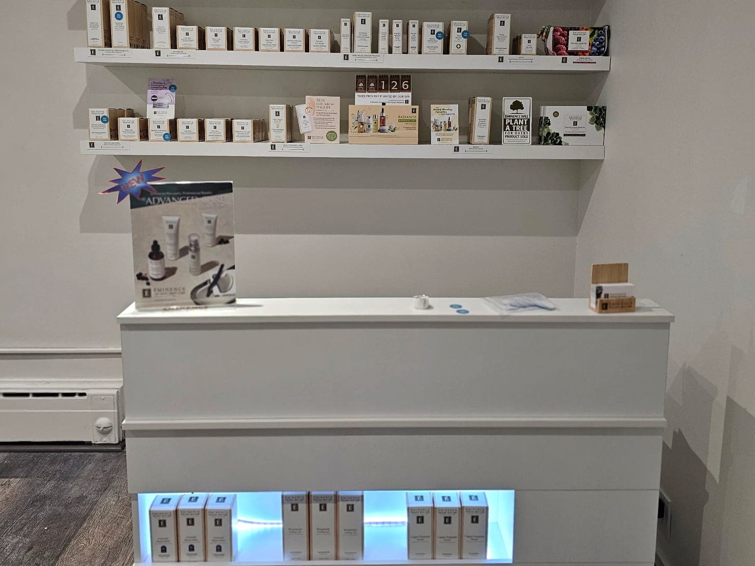 The reception desk and Éminence retail wall at Harav Salon & Spa in Winnipeg